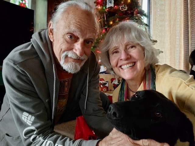 old couple with black dog