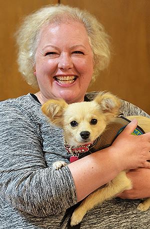 woman holding a dog in her arms