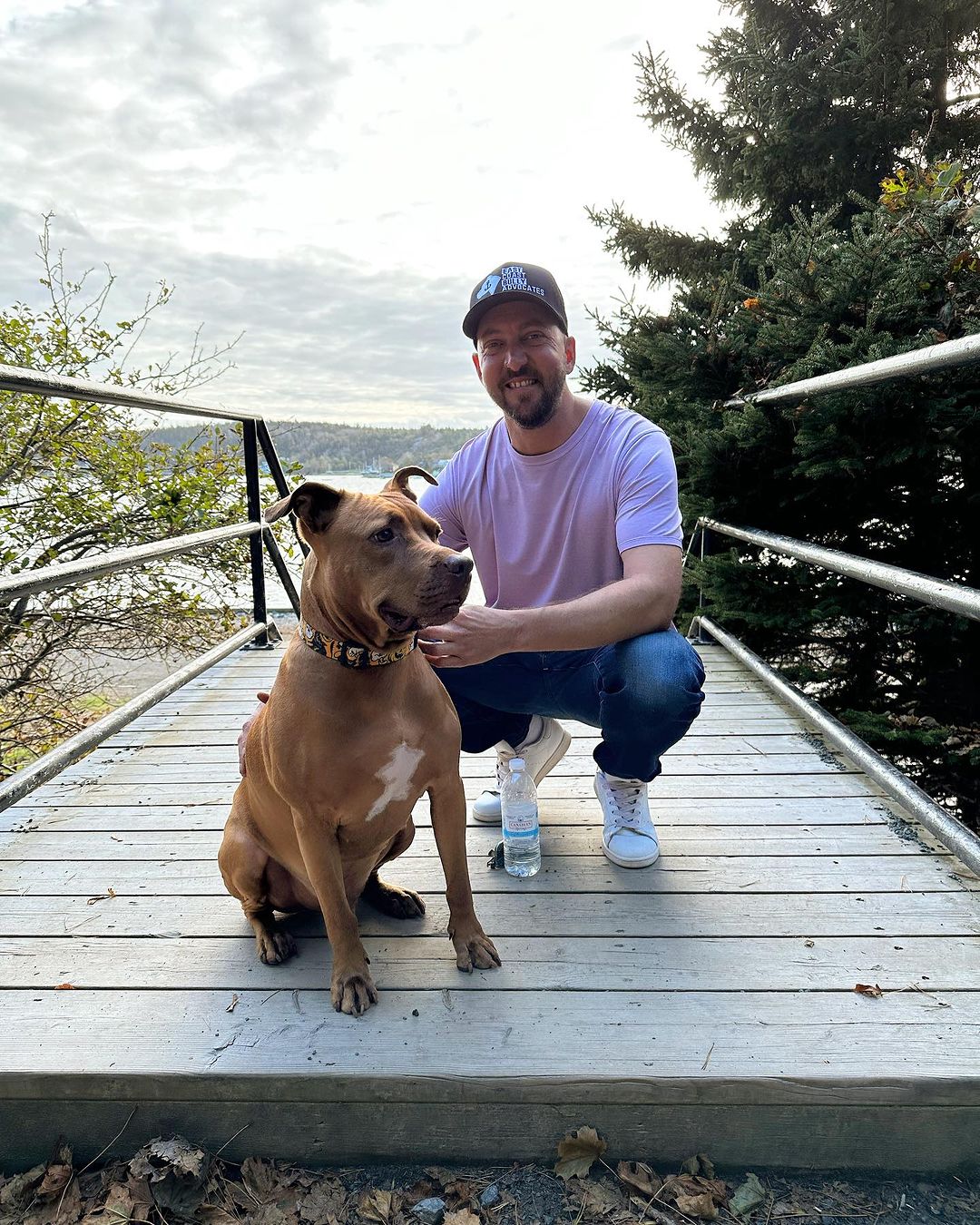 owner and dog posing for picture