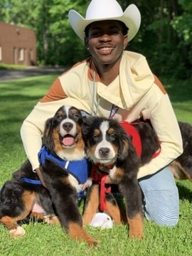 owner and two dog posing for photo