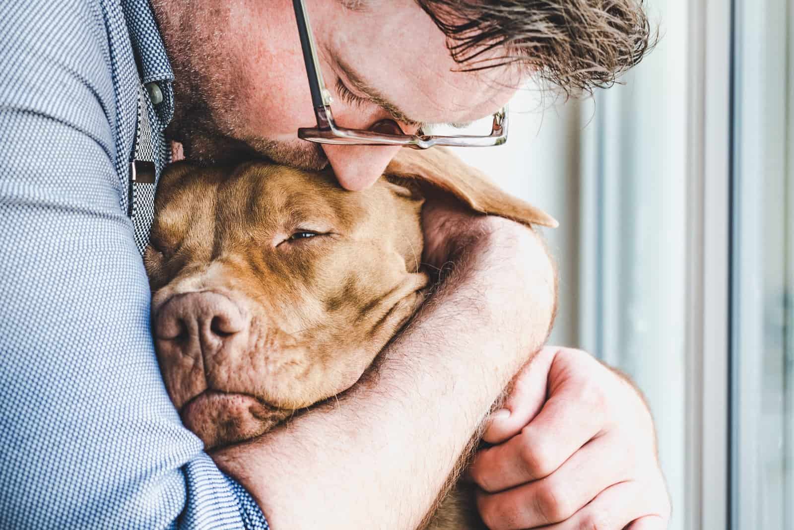 owner hugging sick dog