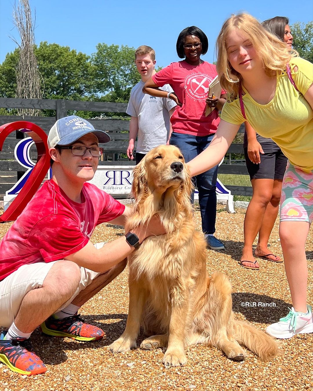 people and dog with golden fur