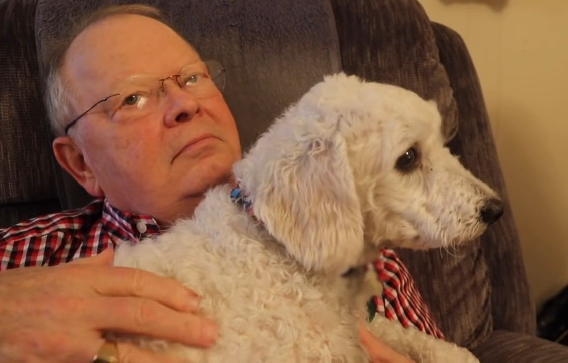 photo of an older man with the puppy