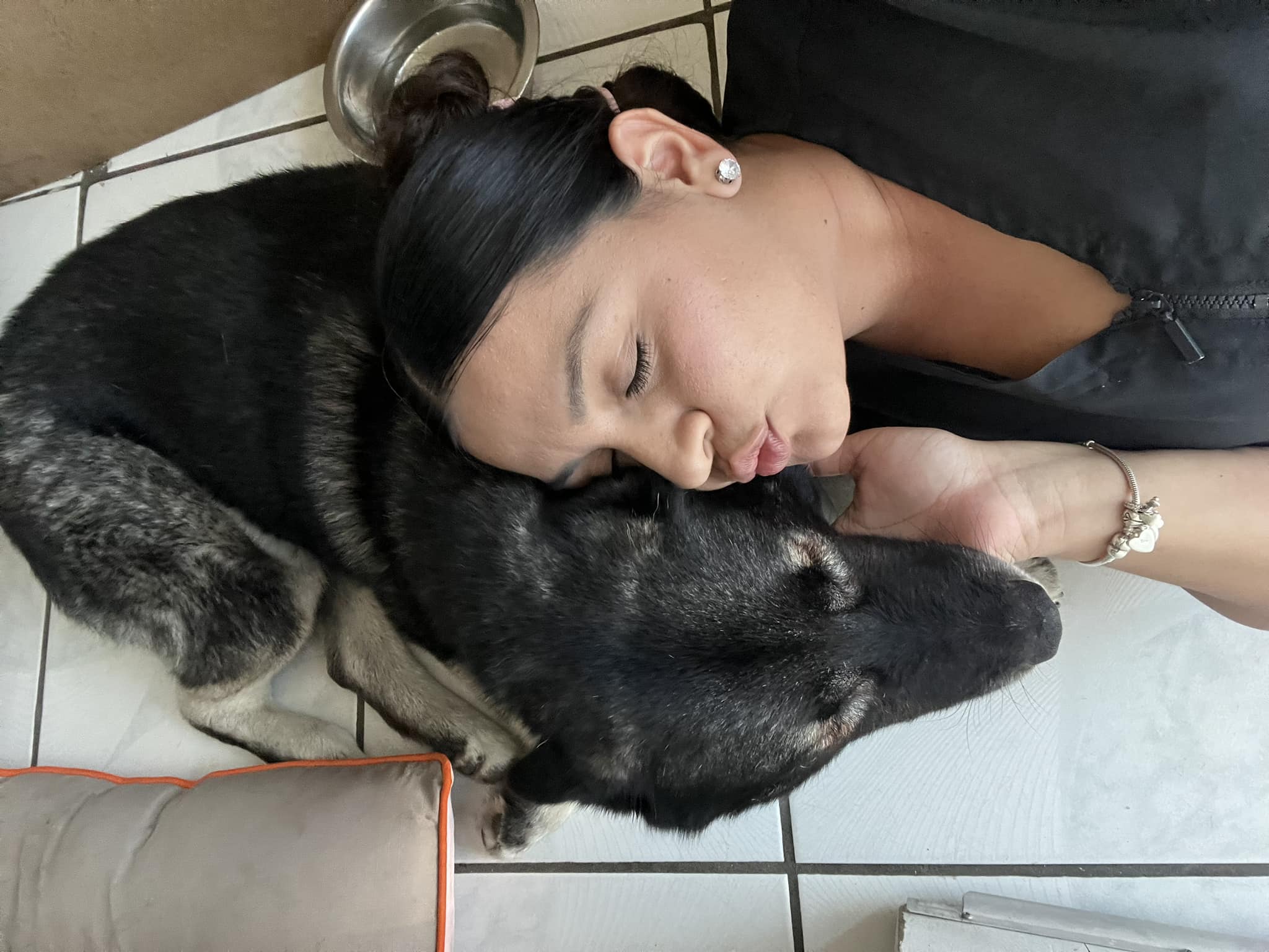 Photo of dog and a woman on the floor