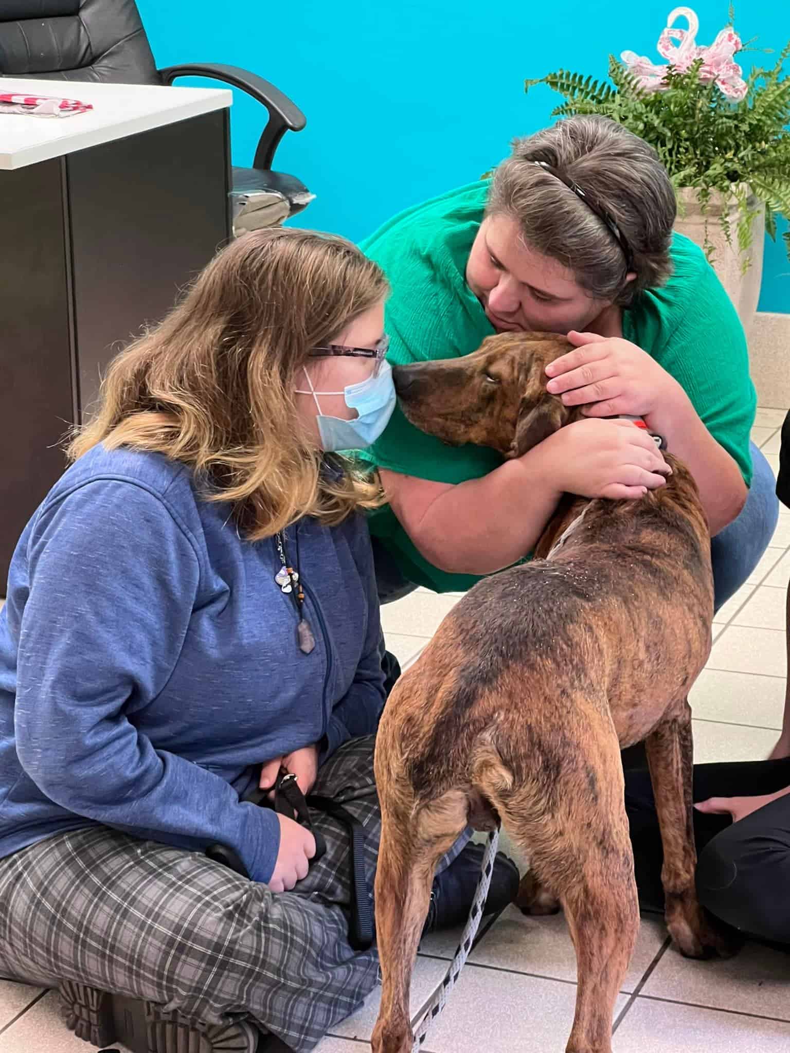 Picaso at the shelter with two woman