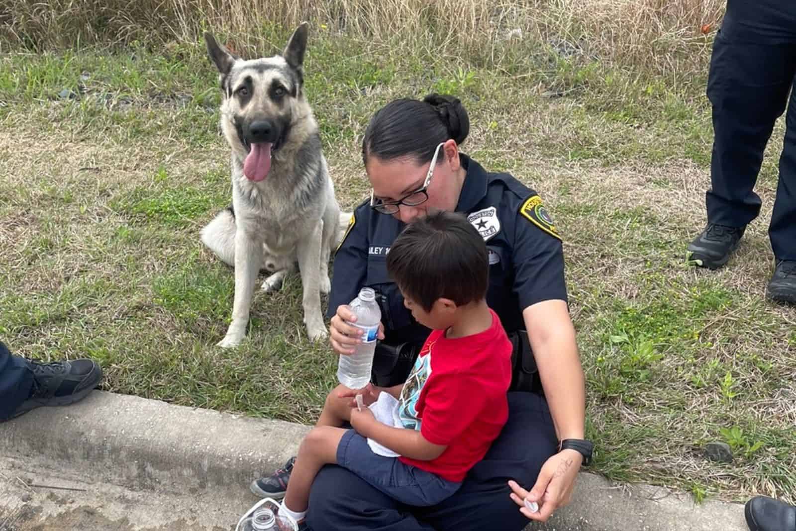 police woman giving a water to the boy