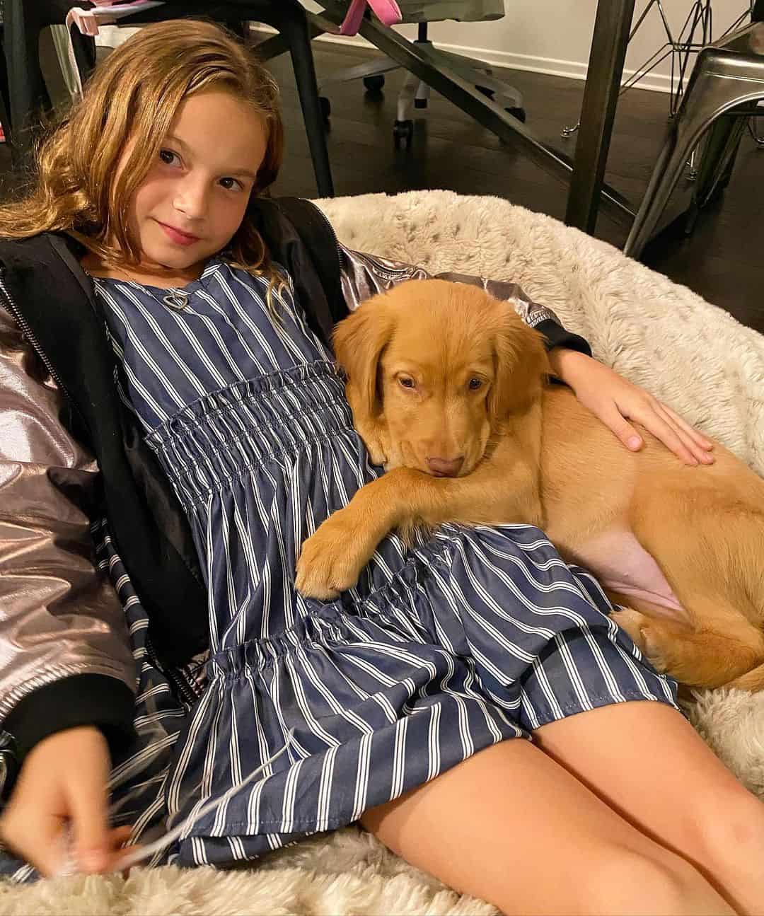 puppy cuddling with a little girl