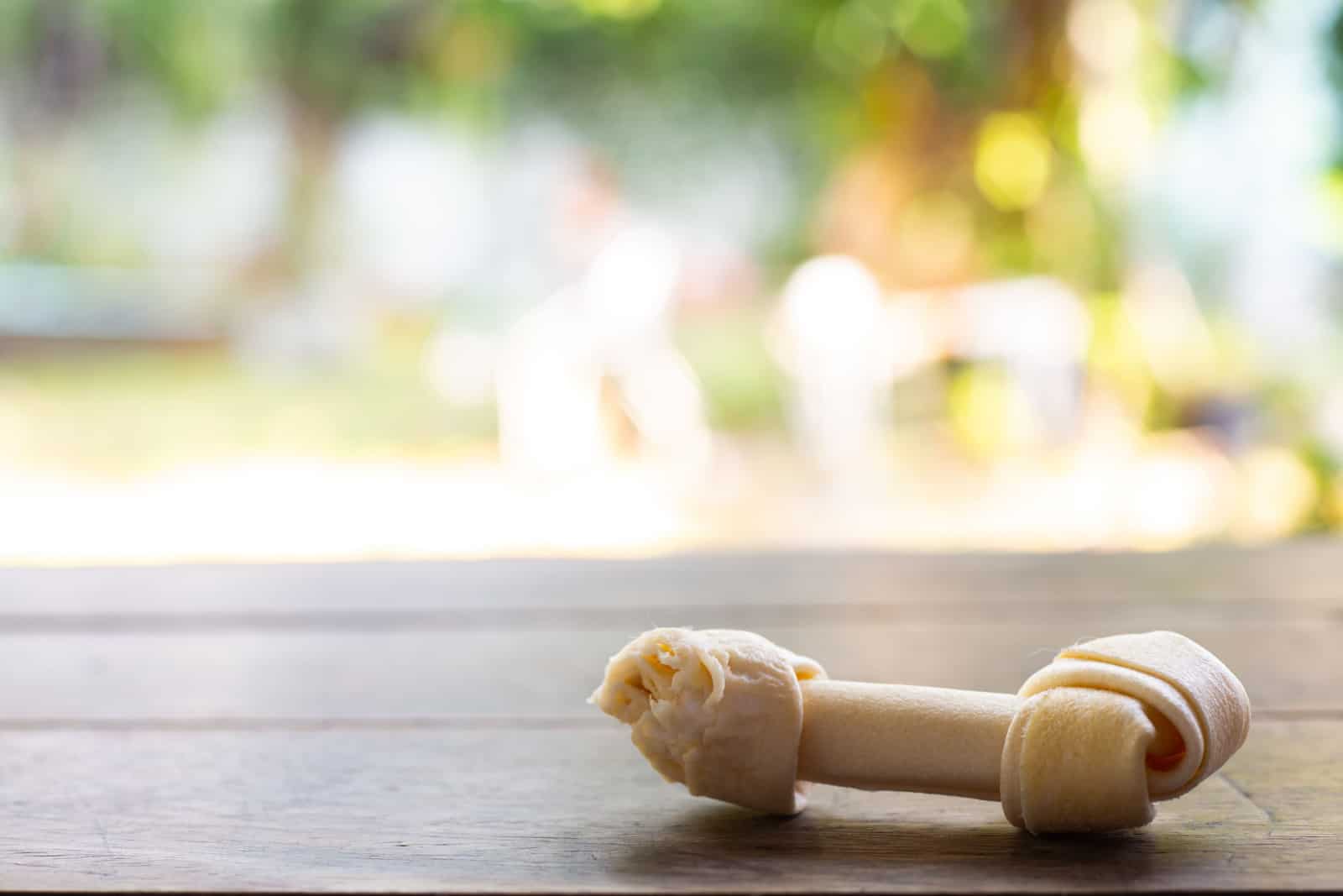 Rawhide dog chews bitten on wooden table