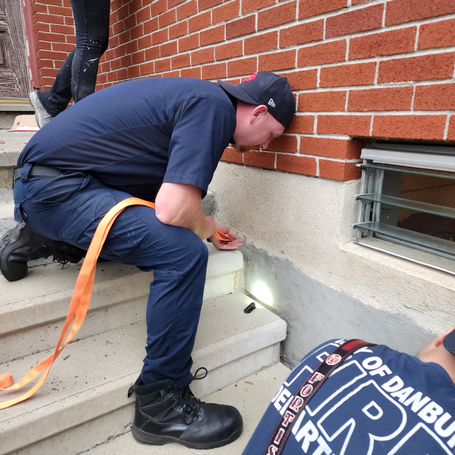 rescuers trying to get kittens from hole