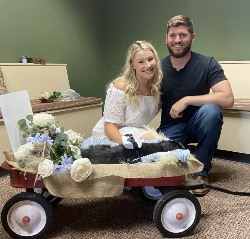 smiling loving couple having a wedding with their dog