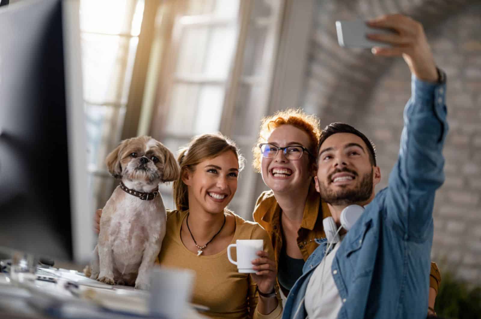 team of young happy business people with a dog having fun