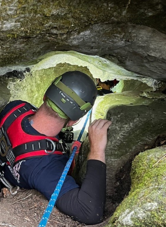 the man descends into the cave