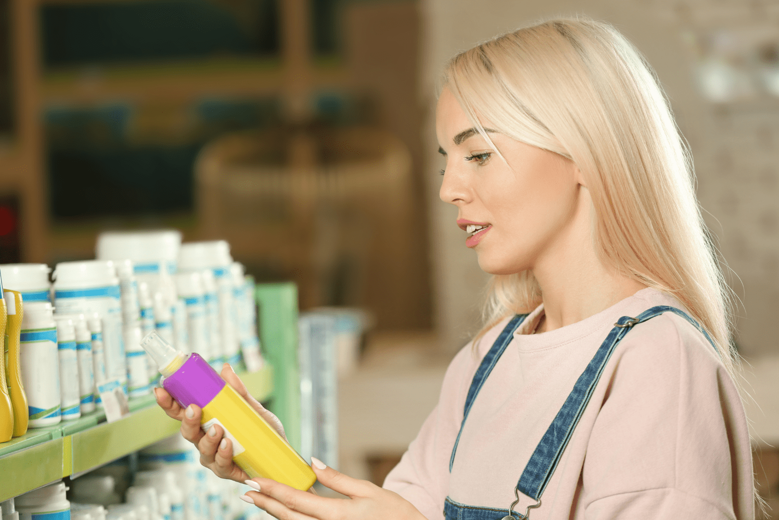 the woman chooses shampoo for the dogs