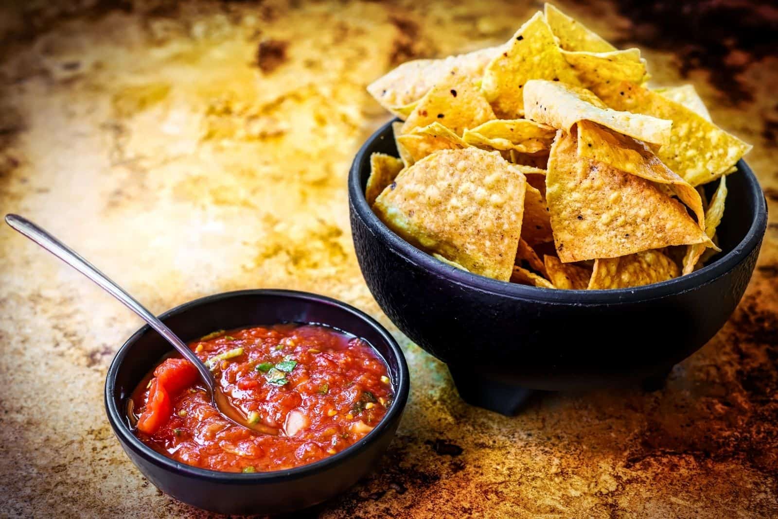 tortilla chips n salsa on the table