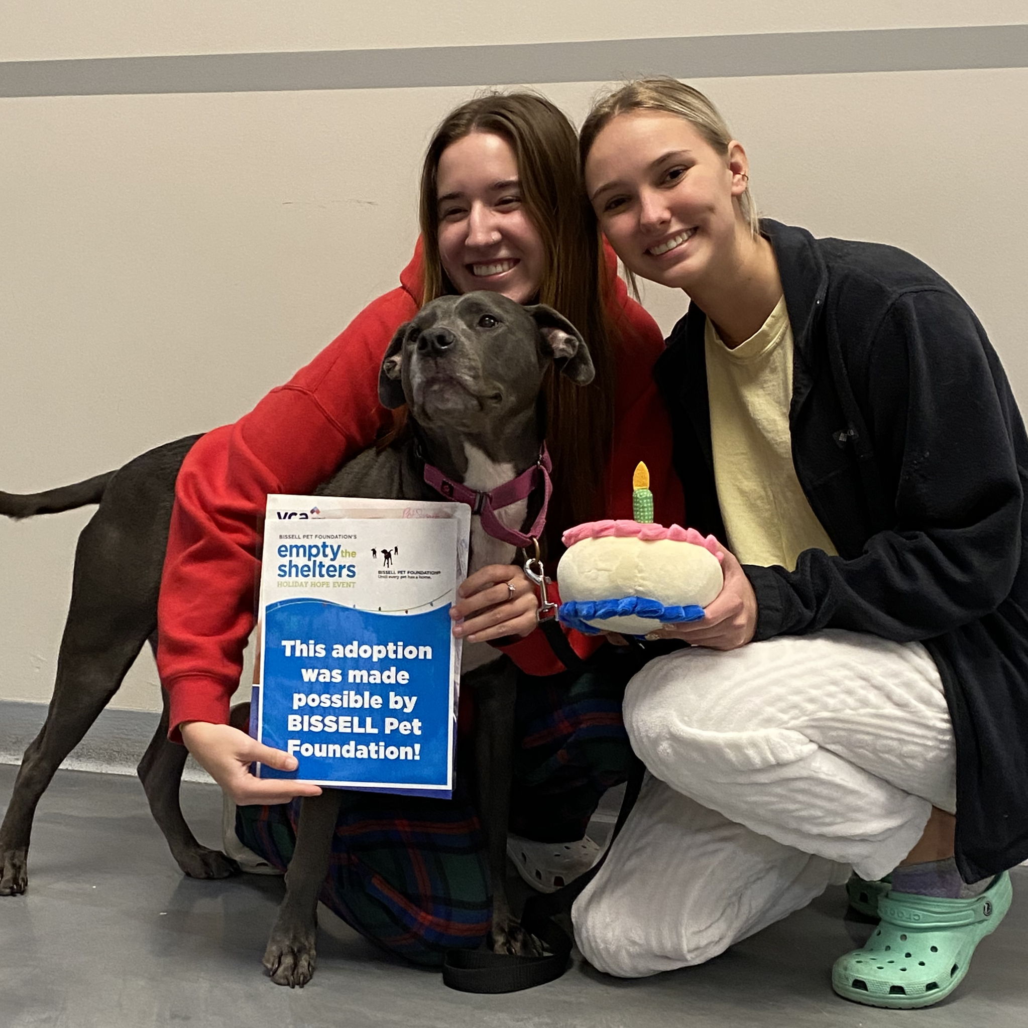 two girls and black dog