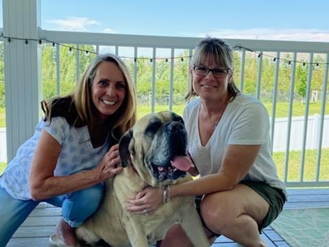 two women with dog posing