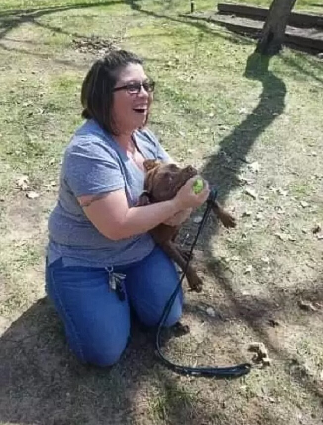 woman and a dog on grass