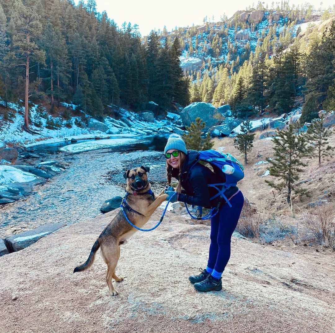 woman and dog in mountain