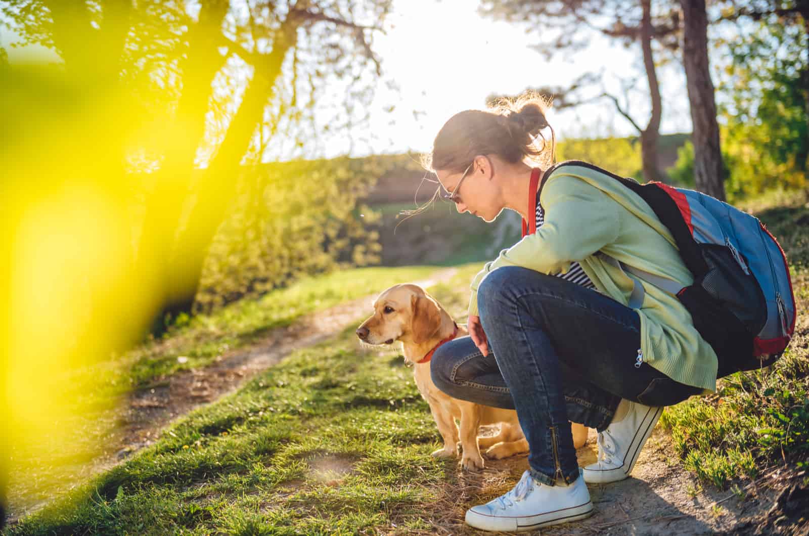 woman and dog outside in nature