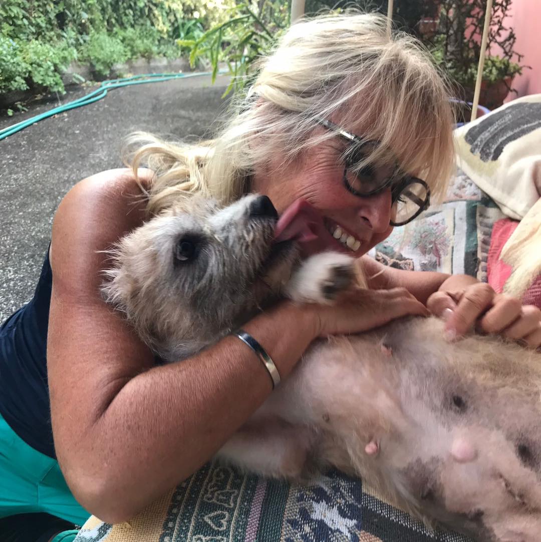 woman cuddling with a dog