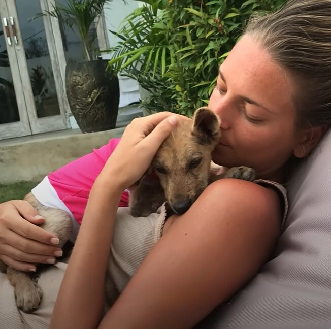 woman cuddling with a dog