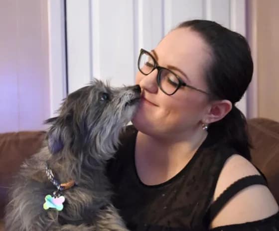 woman cuddling with her childhood dog