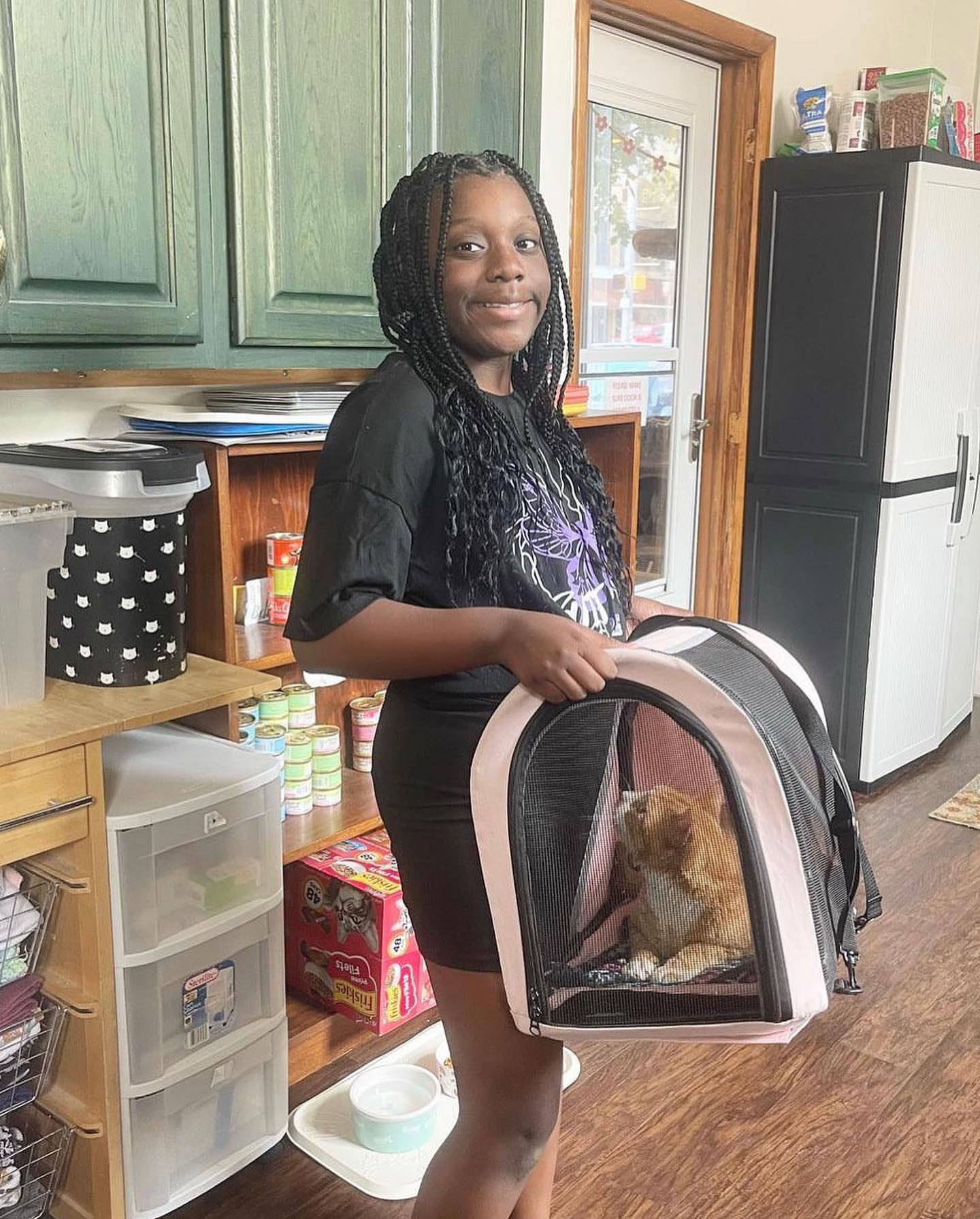 woman holding a bag with a cat