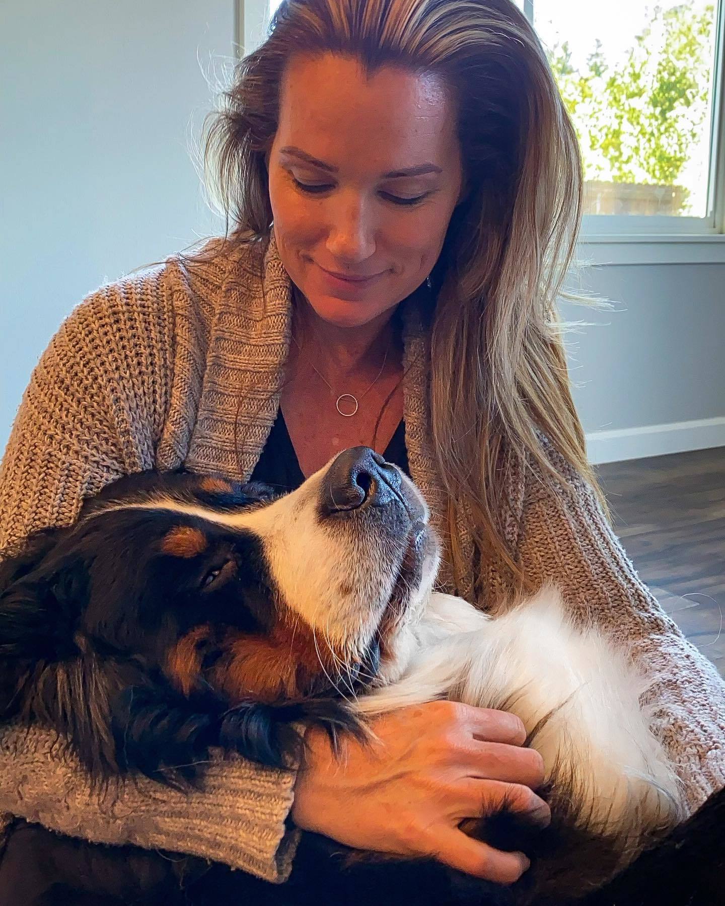 woman holding a bernese in lap