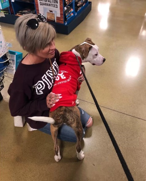 woman holding a dog in her lap