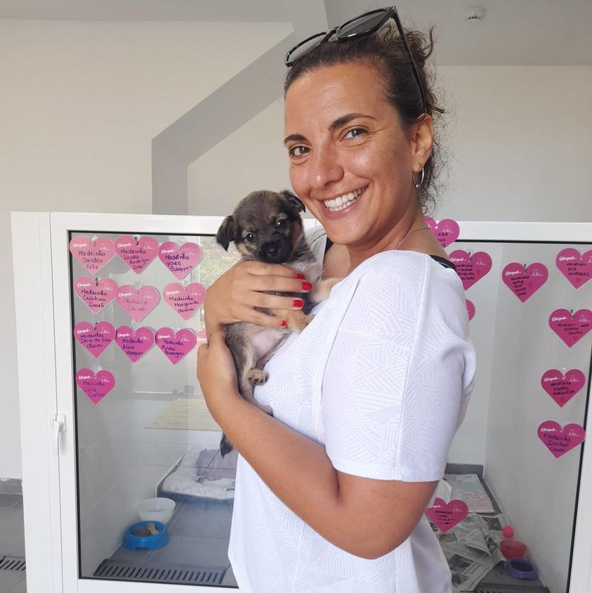 woman holding a puppy