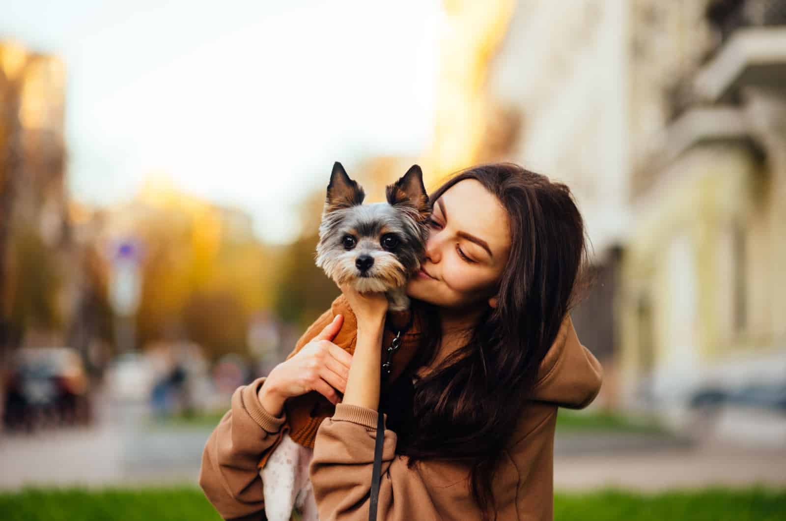 woman holding her yorkie pet