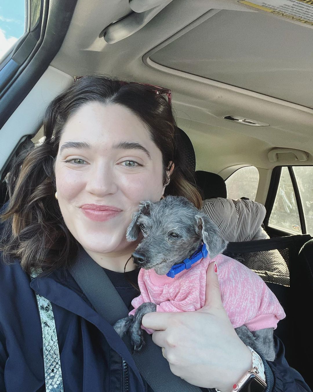 woman holding the poodle