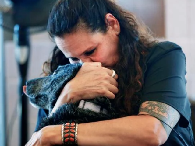 woman hugging deaf dog