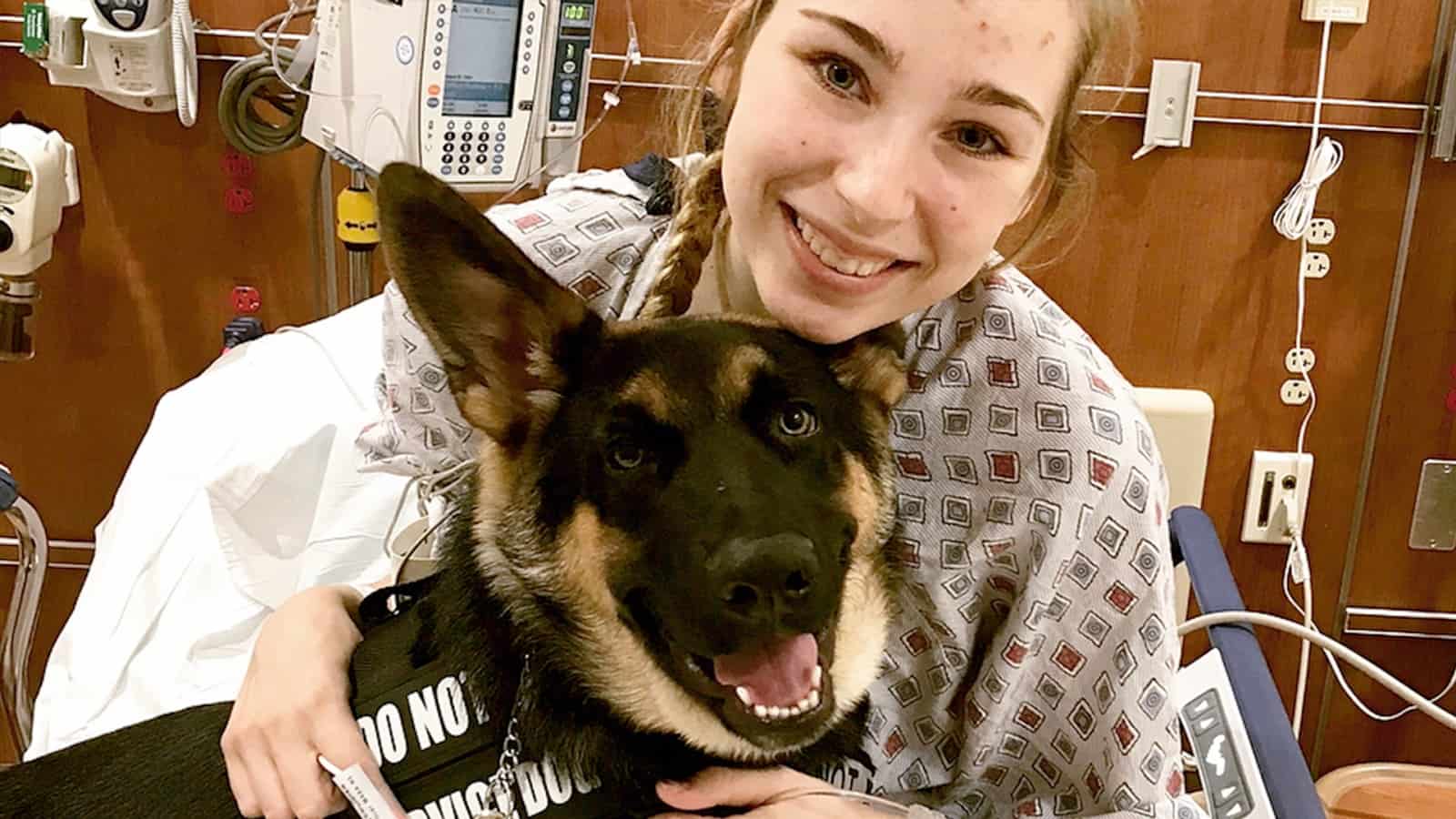 woman hugging german shepherd dog in a hospital