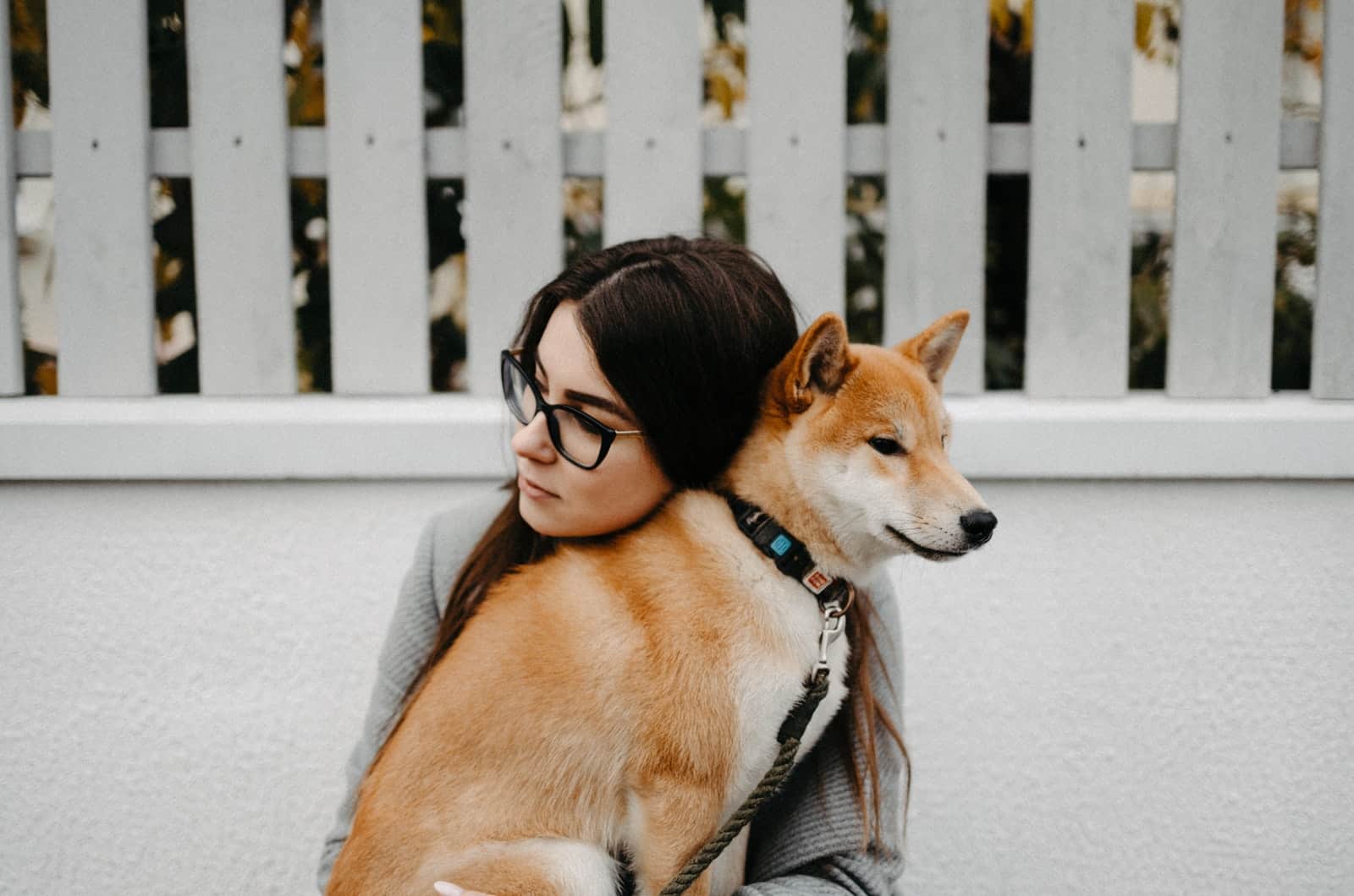 woman hugging her akita inu dog