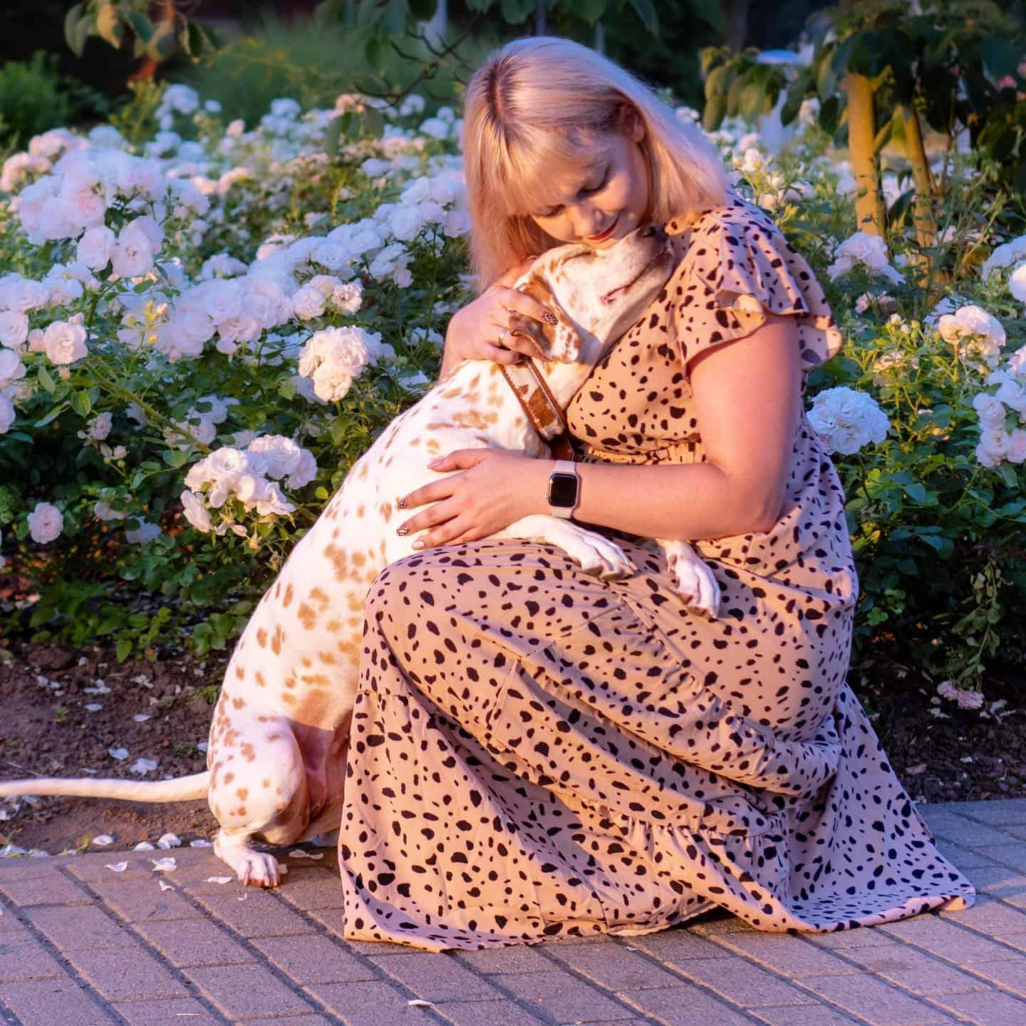 woman hugging with lemon dalmatian dog