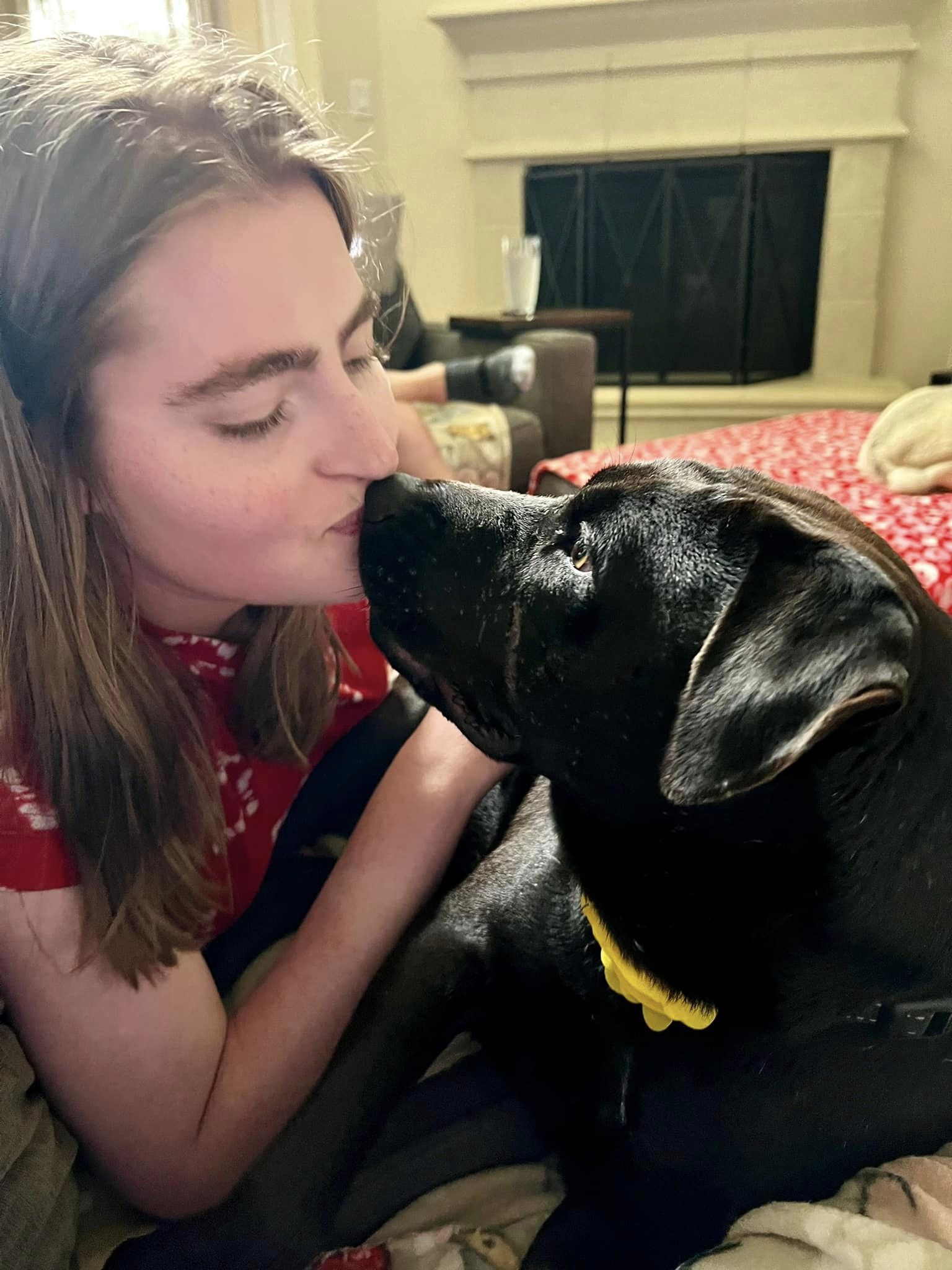 woman kissing the dog