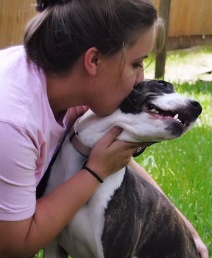 woman kissing the dog