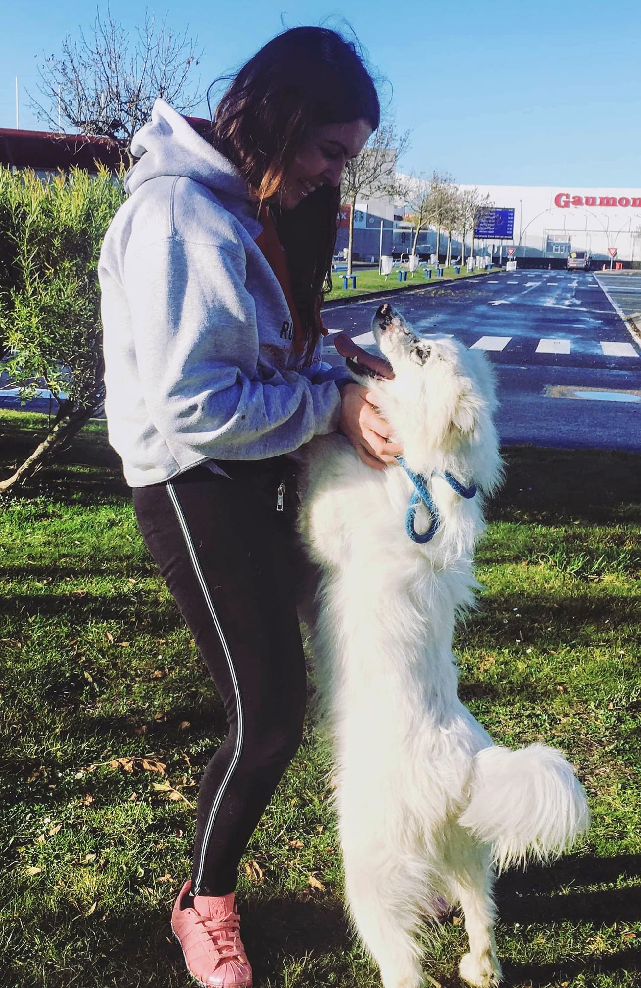 woman petting big white dog