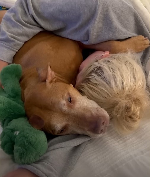 woman sleeping with dog