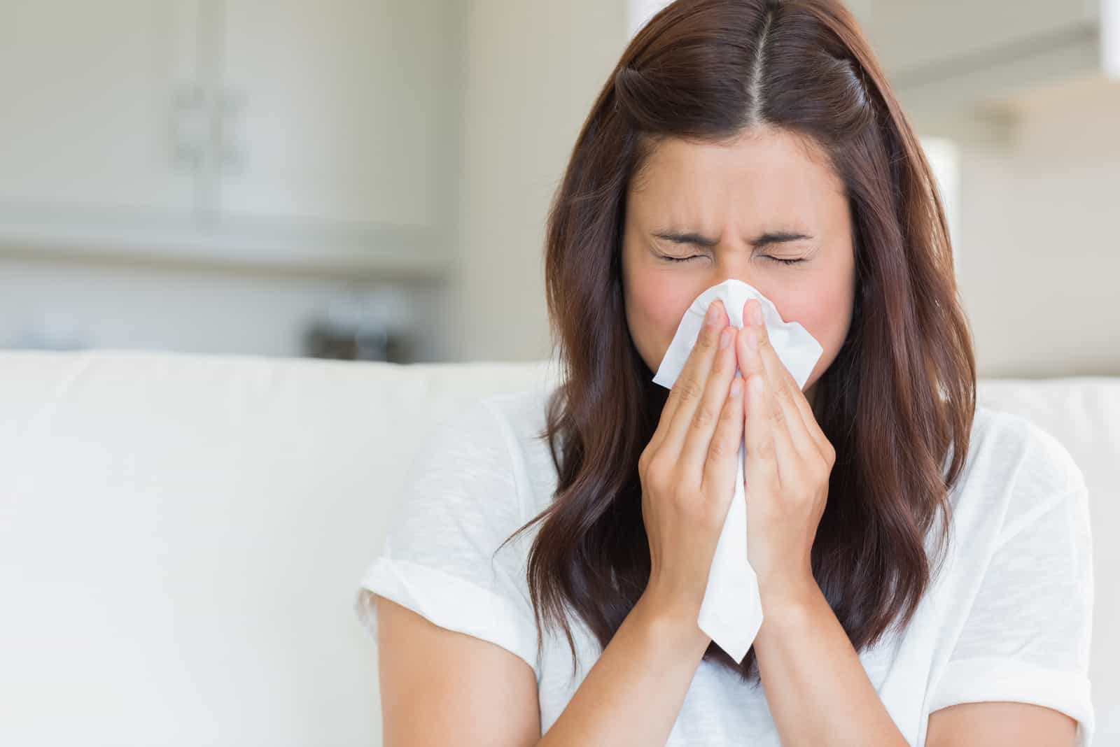 woman sneezing due to an allergy