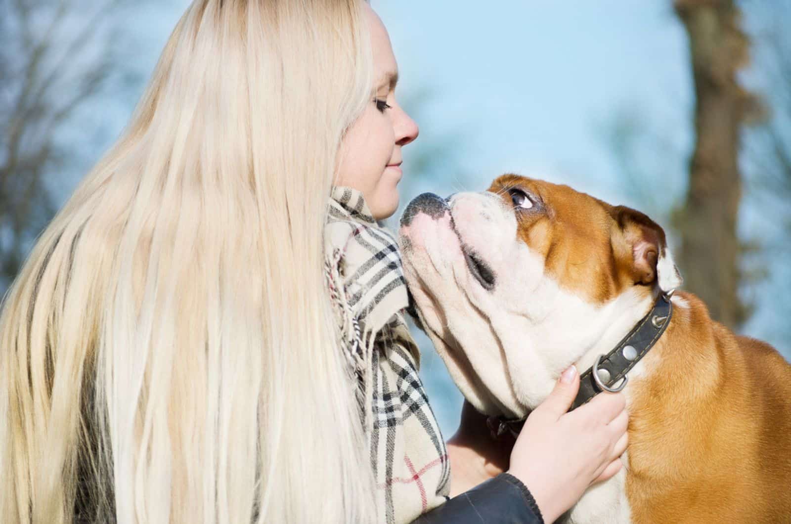 woman with english bulldog in nature