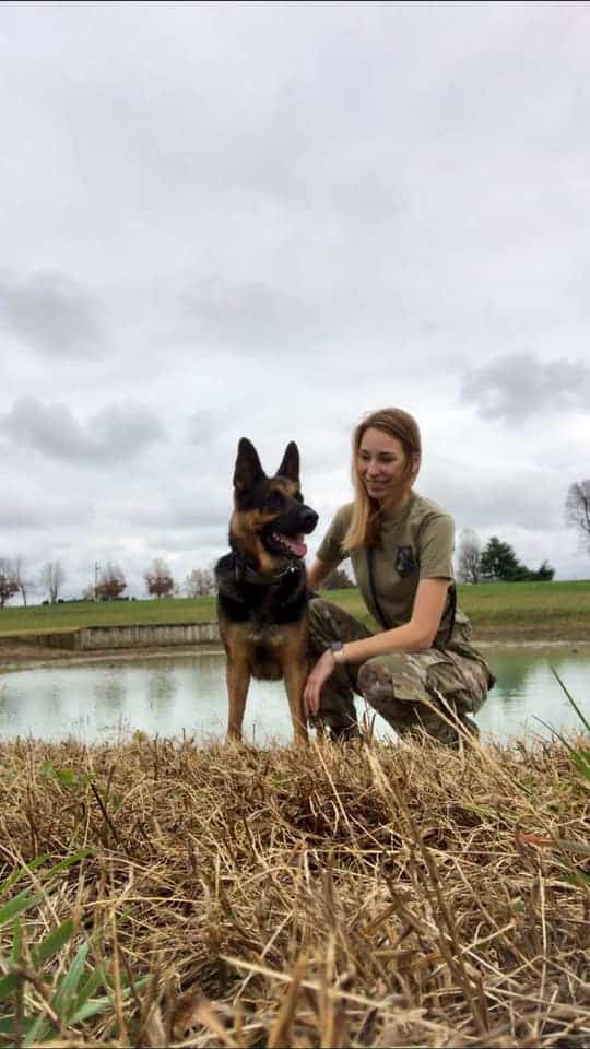 woman with her german shepherd dog in nature