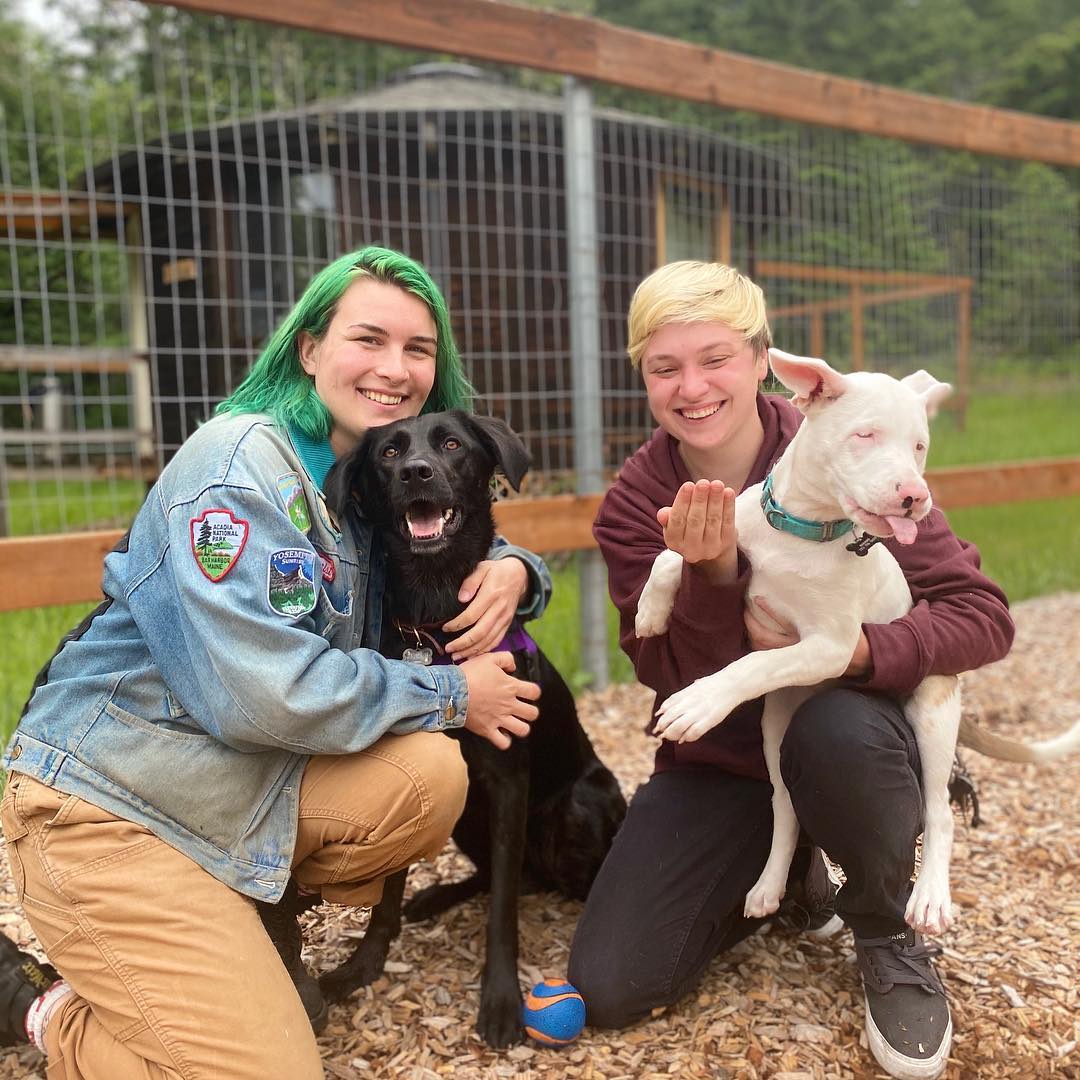 women posing with dogs