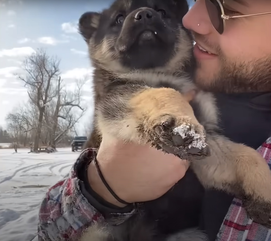 young man with cute puppy