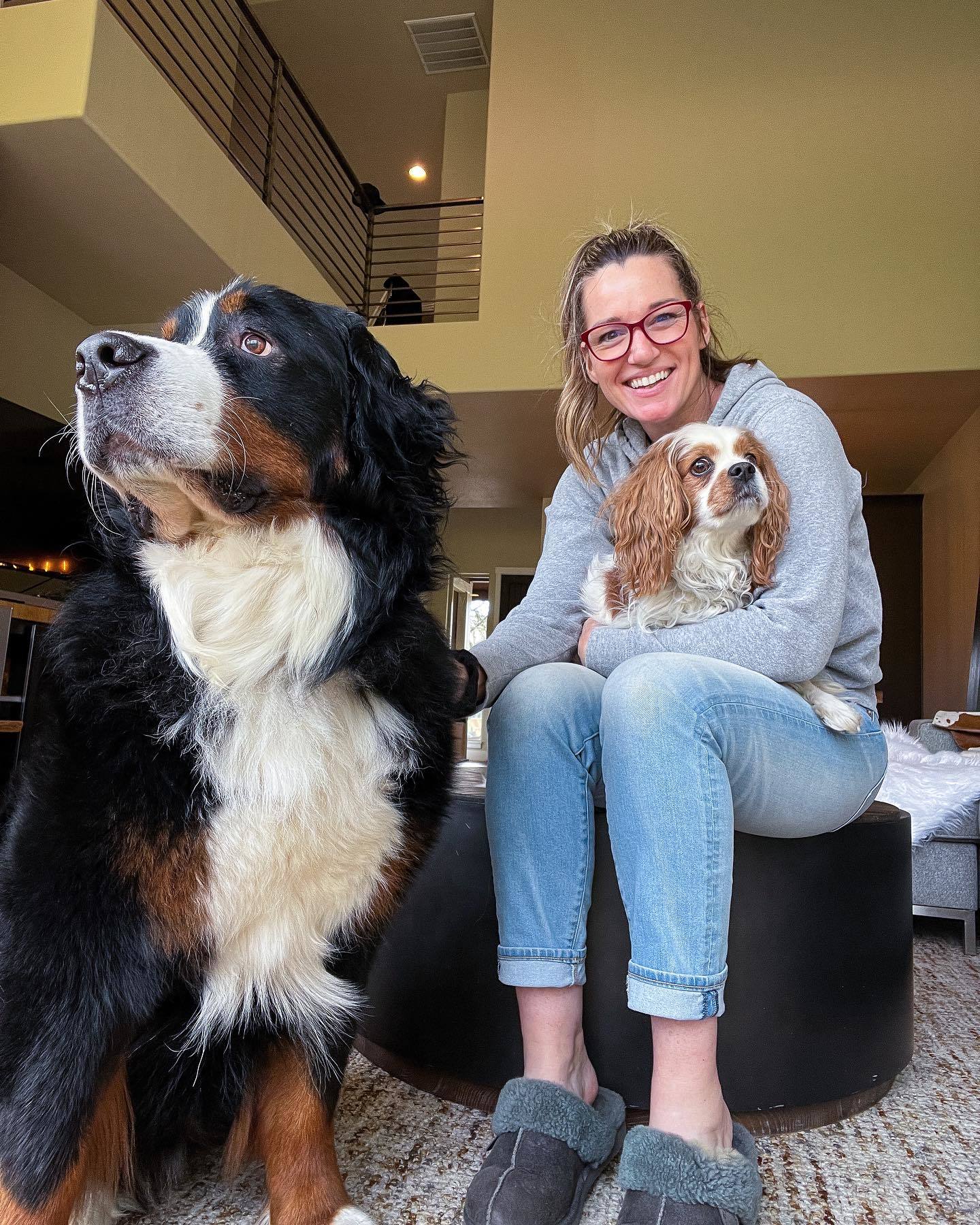 young woman posing with two dogs