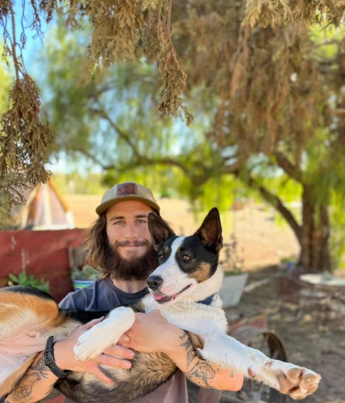 a man holds a rescued dog in his arms