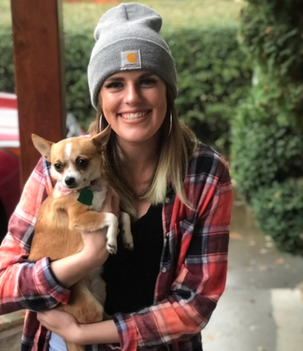 beautiful girl holding a dog