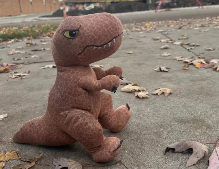 dinosaur toy surrounded by leaves