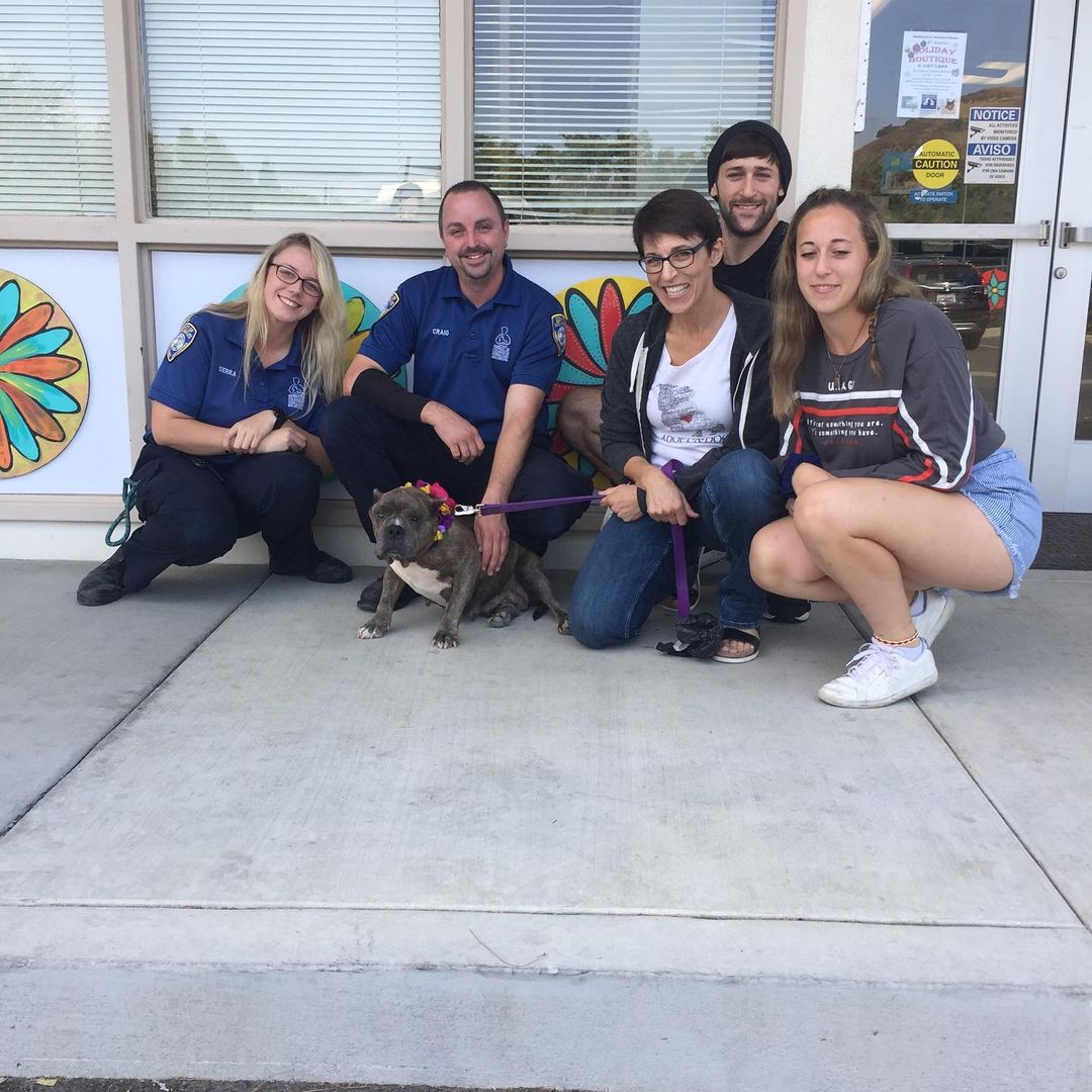 group of people and rescued dog